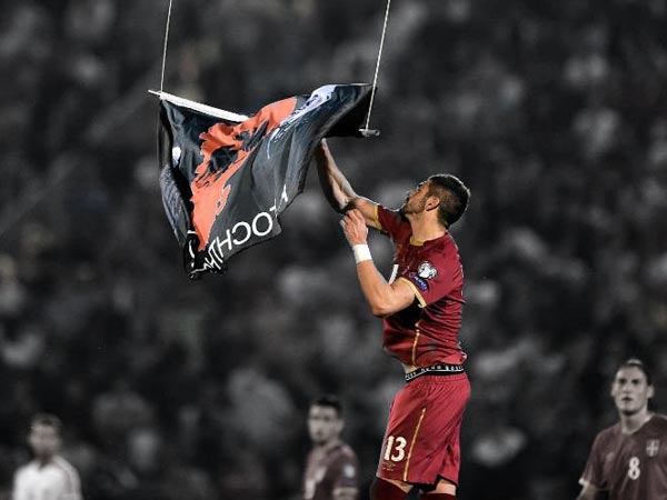 Player tears down a “Greater Albania” flag from drone's undercarriage during the match
